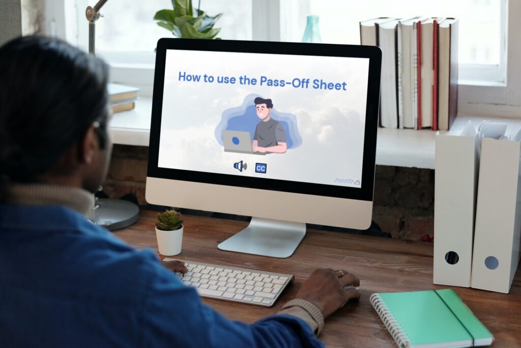 Man at computer looking at Pass-Off Sheete Training